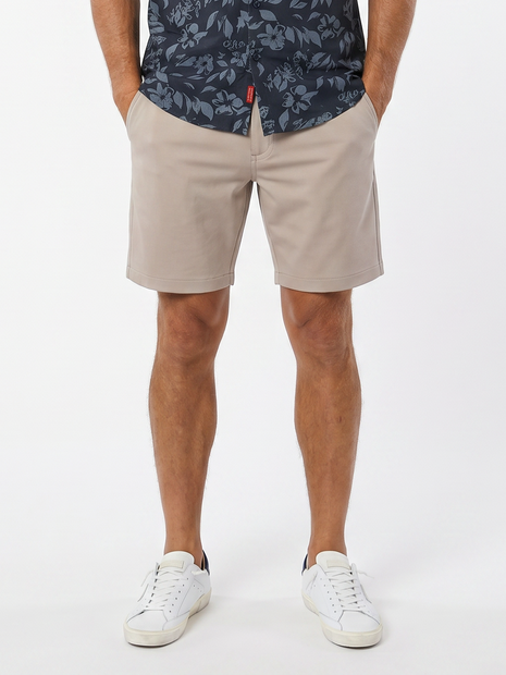MEN'S HALSEY 44 BREAKWATER SPORT SHORTS IN SOLID CASHMERE - FRONT VIEW. STYLED WITH DESOTO SHORT SLEEVE SHIRT IN DARK BLUE WITH FLORAL AND WHITE PHILLIPE MODEL SNEAKERS. 