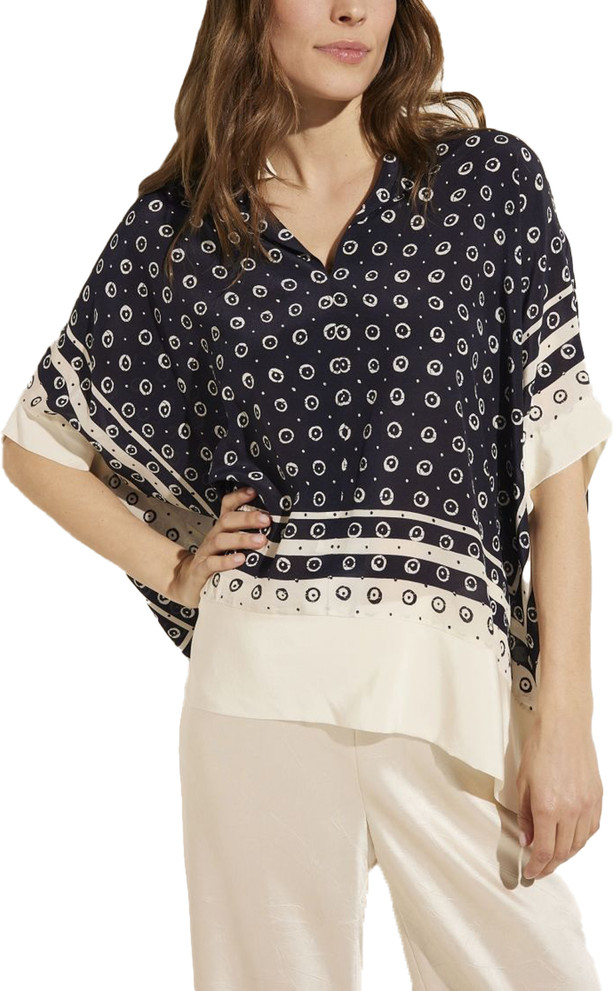 Front view of Antonelli silk blouse. This blouse is a v- neck, oversized with a blue and white dot pattern.