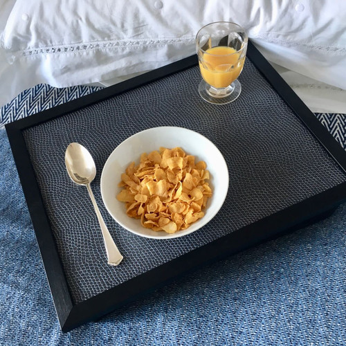 Crock 99 leather lap tray with black frame and breakfast cereal bowl on top of it