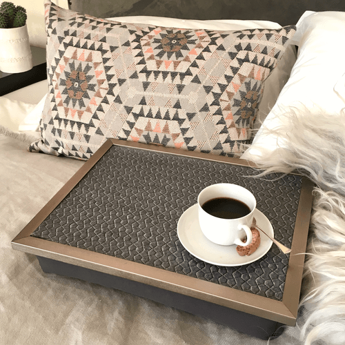 Terra 53 charcoal lap tray with silver frame shown with coffee cup