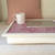 rosy pink lap tray with cream frame and ipad on top of it