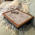 race beige lap tray with wood frame pictured on a sofa