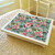 Botanicals turquoise lap tray with cream frame and cream cushion, pictured on a bed