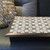 Medina star lap tray with silver frame on a grey leather sofa