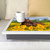 sunflower horse lap tray with cream frame and grey cushion on a sofa