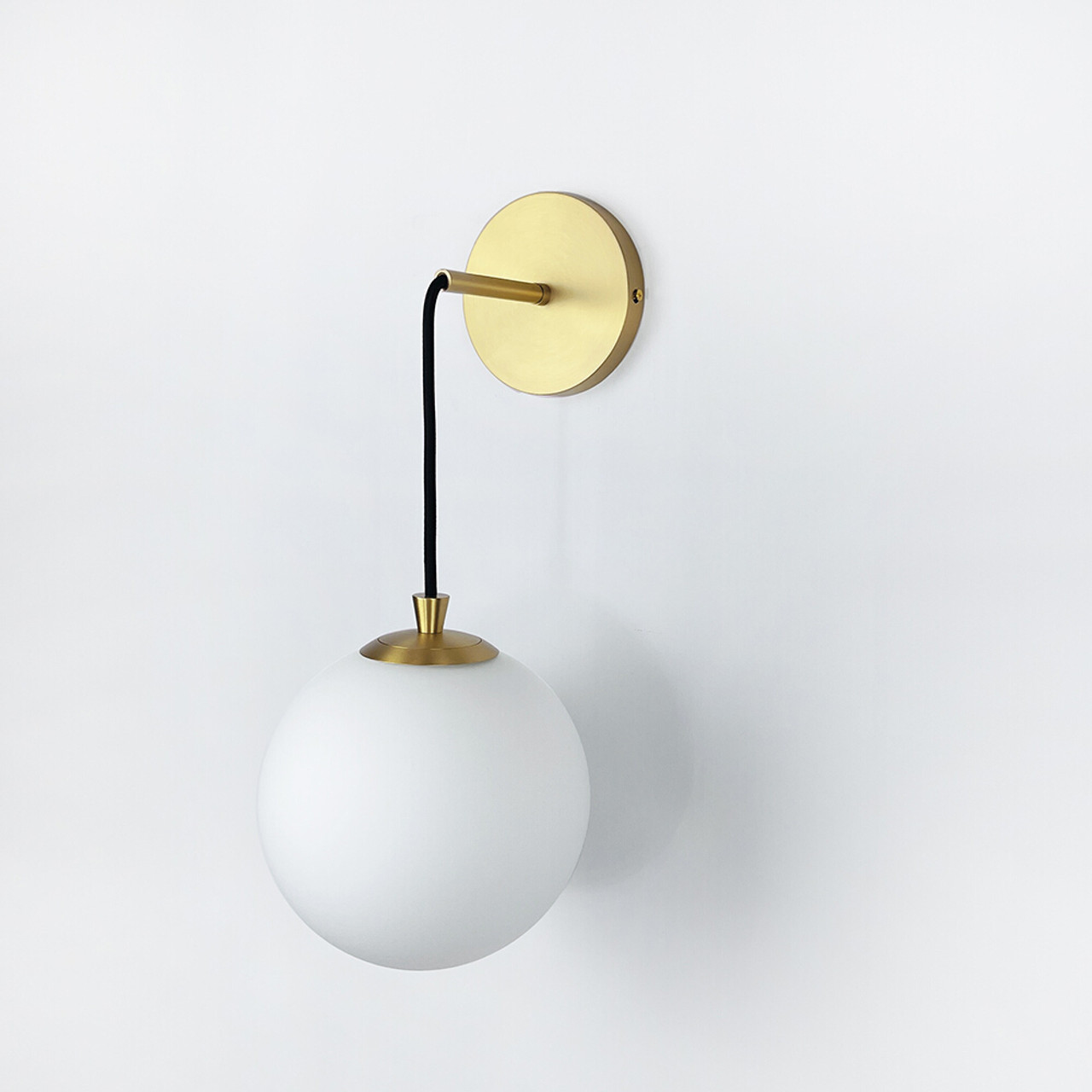 White and brass wall shop sconce