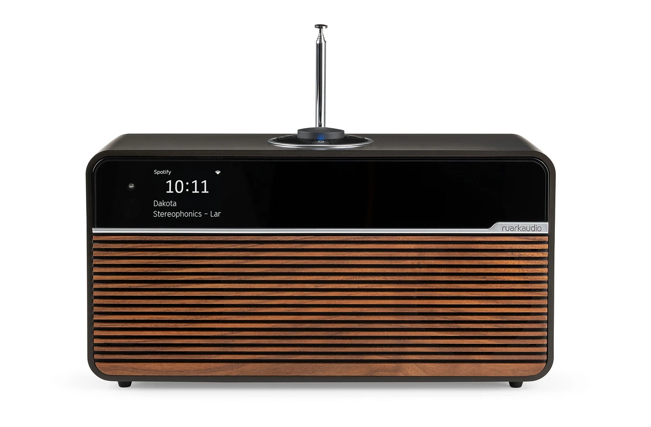 An espresso-veneered one-box music system with a fabric grille and rotary control.