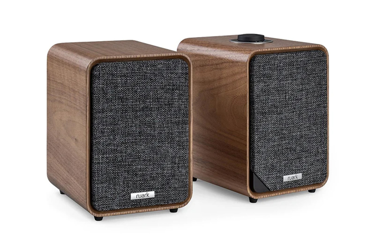 A pair of small walnut-veneered desktop speakers.