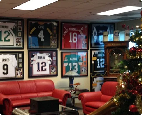 A room lined with framed football jerseys