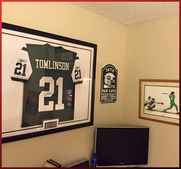 Framed LaDainian Tomlinson jersey hanging in a hallway
