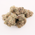 KOI THCA Flower | Lemon Cherry Gelato Buds. Zoomed-out image of KOI Lemon Cherry Gelato THCA Flower buds highlighting their dense structure and tangy aroma.