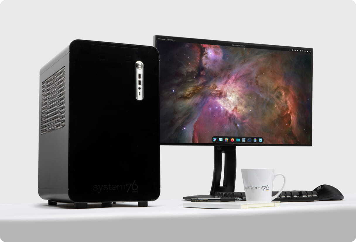 Thelio Mira desktop sitting on a desk with Pop!_OS on a monitor 