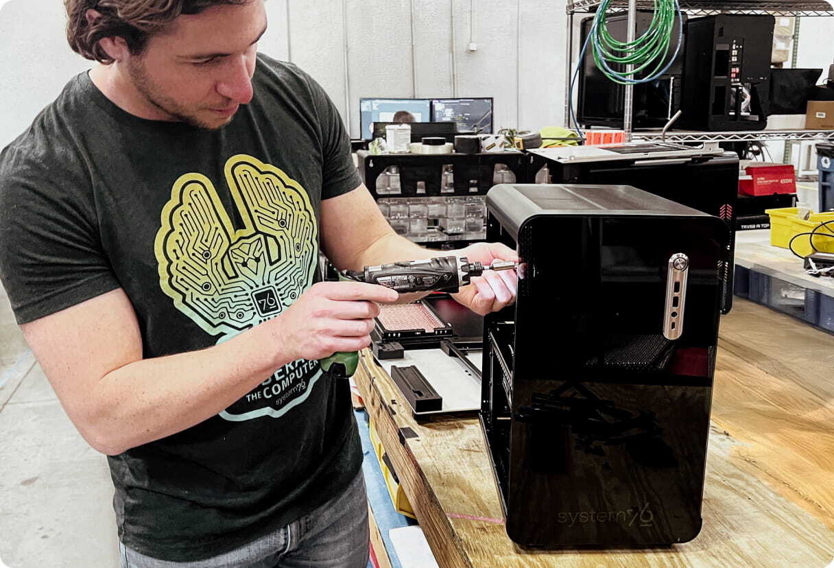 System76 engineer screws in a bolt into the Thelio Mira Desktop prototype