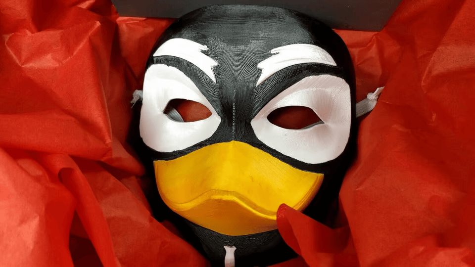 3d-printed Guy Tux mask in a shipping box with red tissue