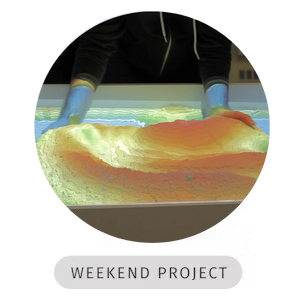 Photo of someone's hands in the AR Sandbox