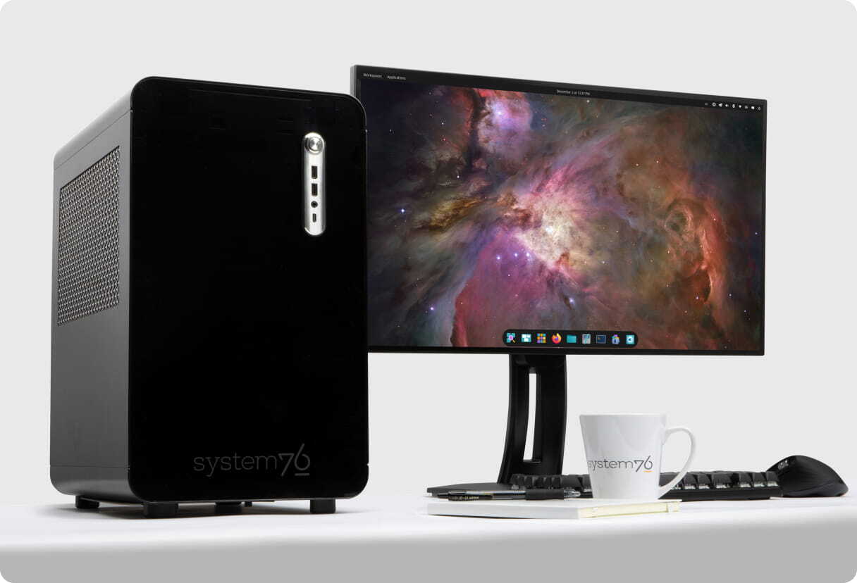 Thelio Mira desktop sitting on a desk with Pop!_OS on a monitor 