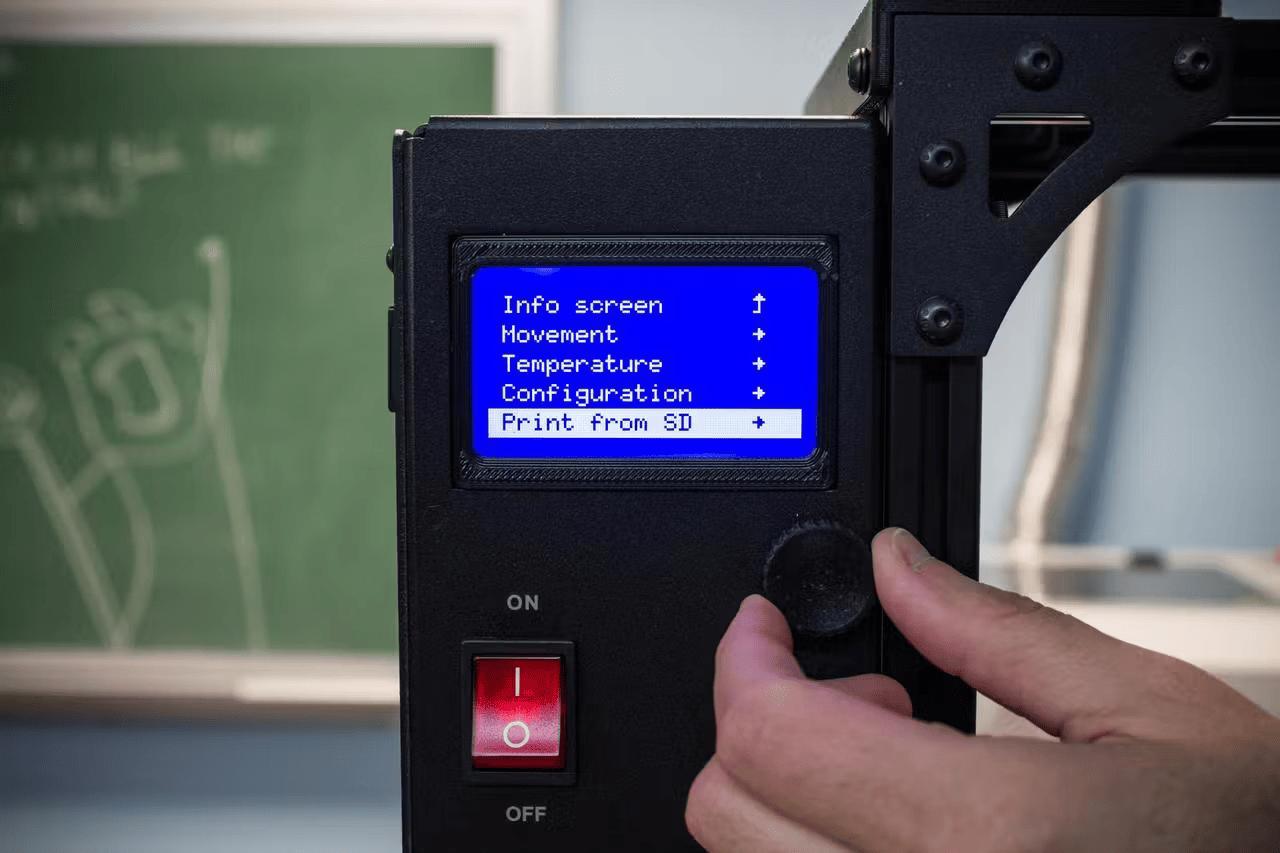 photo showing someone turning the knob settings on a lulzbot 3d printer