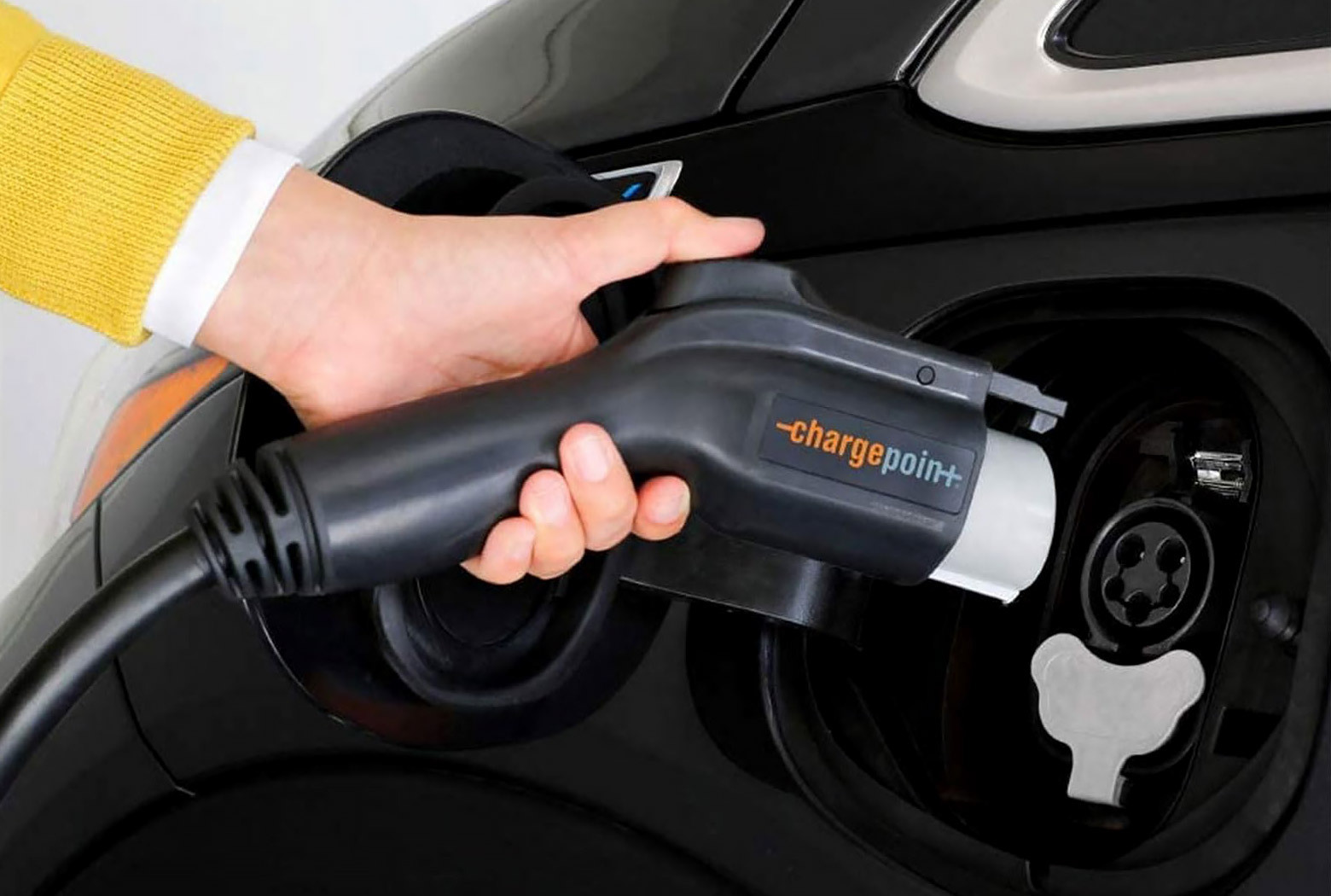 person hand plugging the Chargepoint charger in an electric vehicle