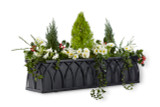 Arch window box with a black galvanized liner and plants.