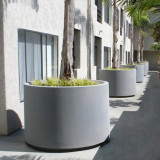 Large round Marek Planters lined up by a condominium complex Large round Marek Planters lined up by a condominium complex
