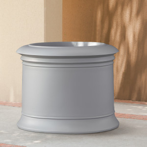 Solerno Fiberglass Round Planter by a building Solerno Fiberglass Round Planter by a building