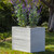 Baxter Fiberglass Square Planter planted in a park like setting