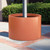 Modern round post planter shown in terracotta in the closed position.