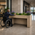 A man in wheel chair accessing ADA-Friendly Provincial Fiberstone Raised Garden Planter in a corporate lobby