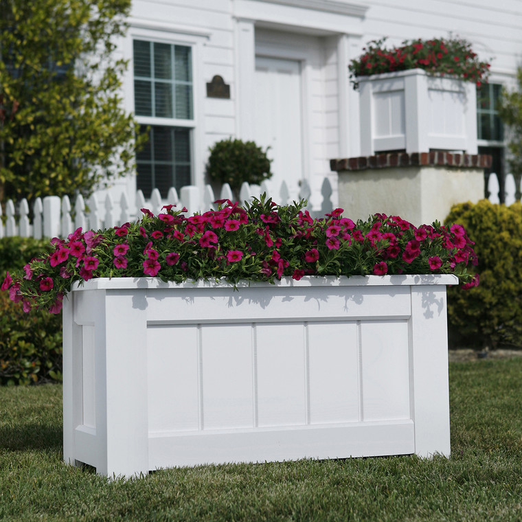 Coronado planter with flowers at a residence.