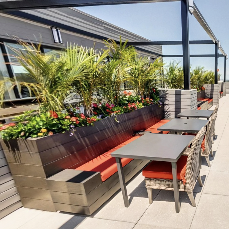Madera Faux Wood Fiberglass Storage Benches located by a hotel pool to provide seating