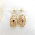 Pair of ornate 9ct gold garnet set earrings
