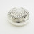 Beautifully embossed circular silver pill pot with gilt interior