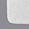 Corner of white Oxford Spa Bath rug