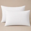 Two white Palmetto quilted pillow shams.