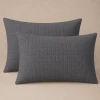 Two gray Palmetto quilted pillow shams.