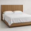 Martex Wavy Jacquard top sheet on a simple wooden bed.