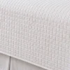 Closeup image of the quilting pattern of a quilted coverlet.