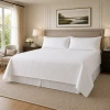 A white king size coverlet set in a room setting.
