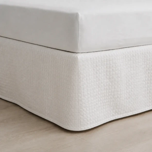 Detail look at the white quilted Palmetto bed skirt.