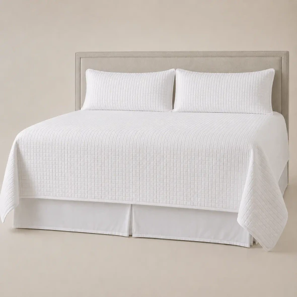 A white king size Palmetto Quilted Coverlet Set on a light color background.