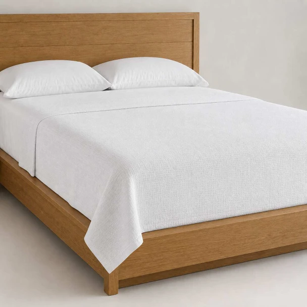 Martex Utica top sheet on a simple bed.