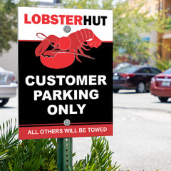 Aluminum parking lot sign on a pole