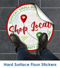 Hard surface floor stickers with "shop local" text, die-cut in a circle with someone standing on the image for size reference. 