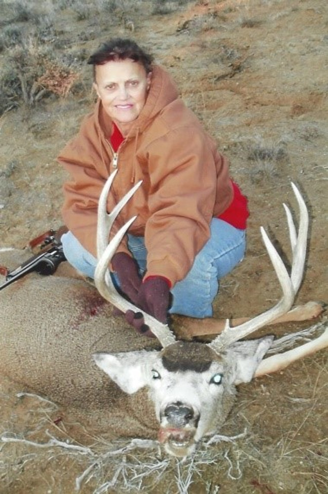Young hunter and muley buck deer.