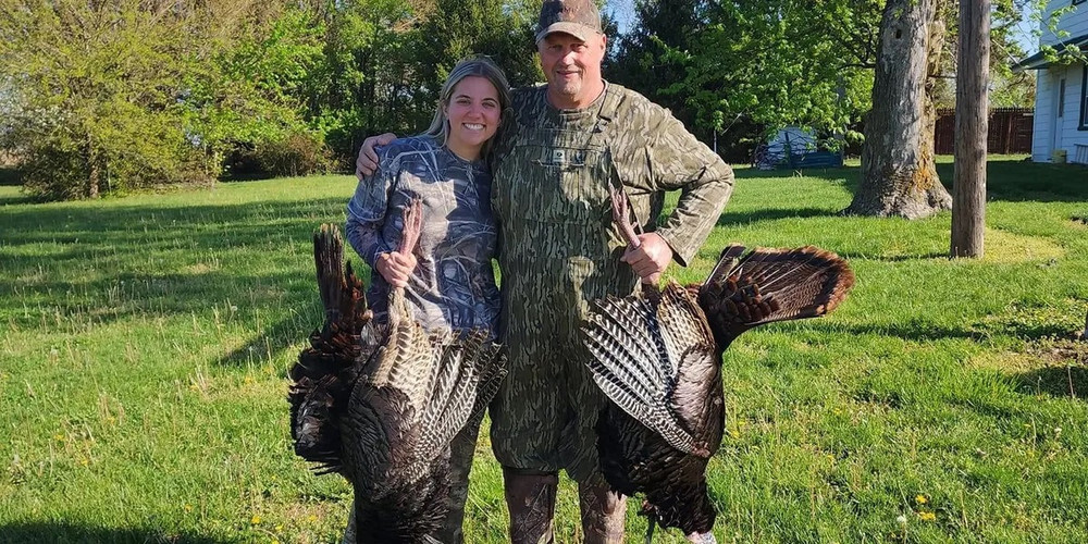 Proud pappa with daughter and turkey trophies.