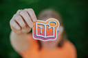 girl holding up orange bring your bible sticker girl holding up orange bring your bible sticker