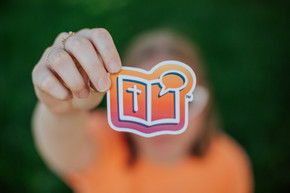 girl holding up orange bring your bible sticker girl holding up orange bring your bible sticker