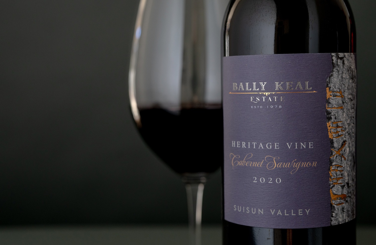 Hands holding ripe Cabernet clusters at Bally Keal Estate