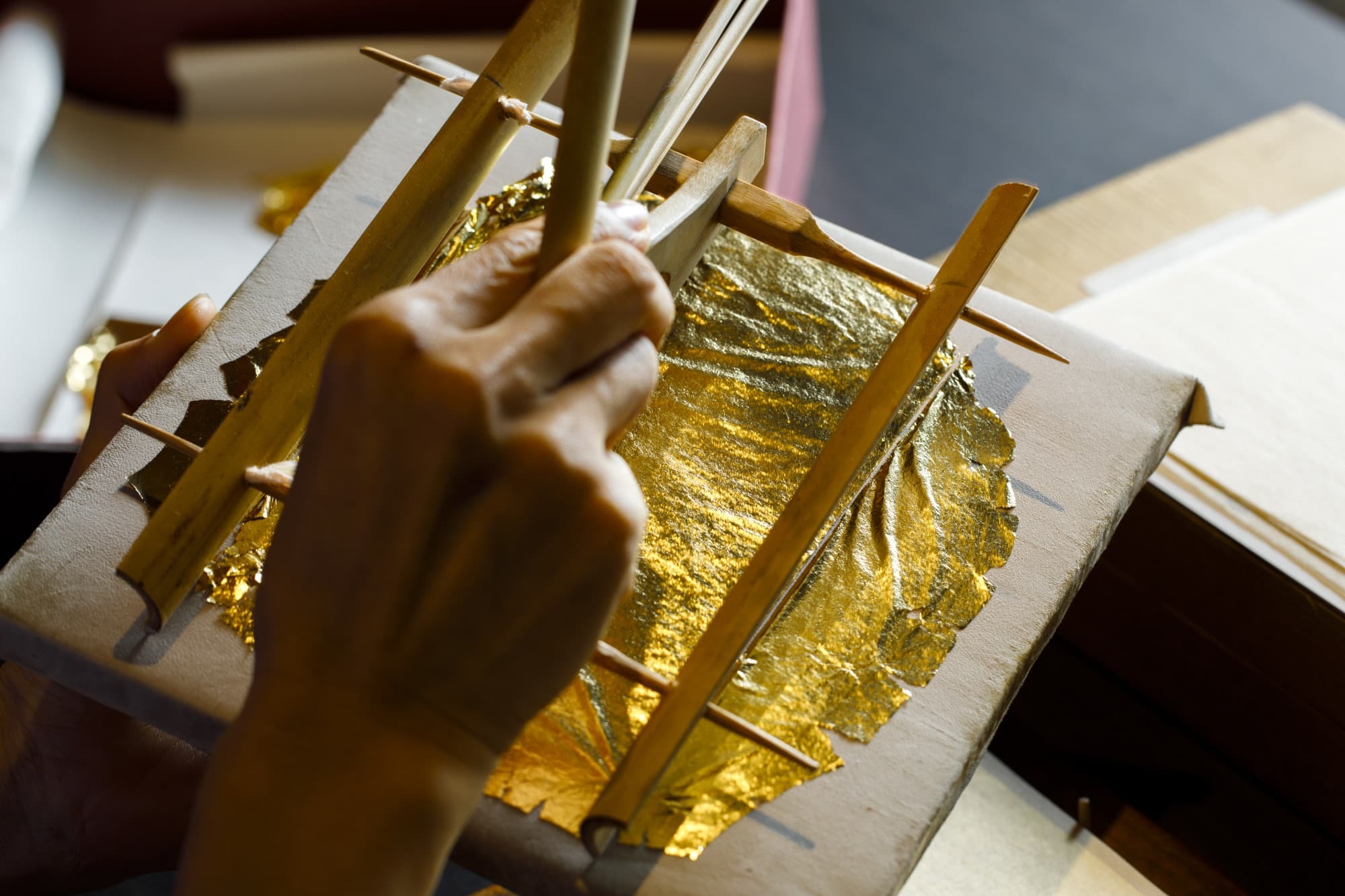 Artisan applying Kanazawa gold leaf - Master Craftsmanship of a micro-thin layer of real gold