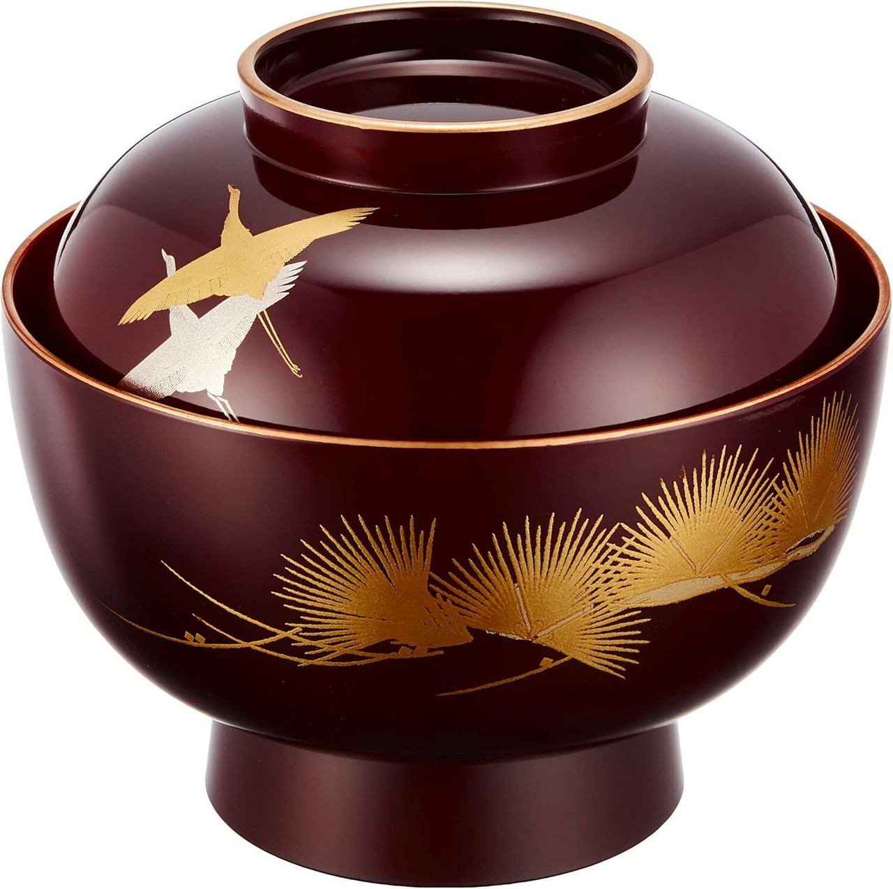 A deep reddish-brown lidded Yamanaka zoni bowl with two cranes in gold and silver on the lid and a gold pine branch around the body